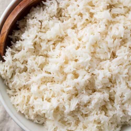 Overhead view of a large bowl of Instant Pot basmati rice with a wooden spoon on a table