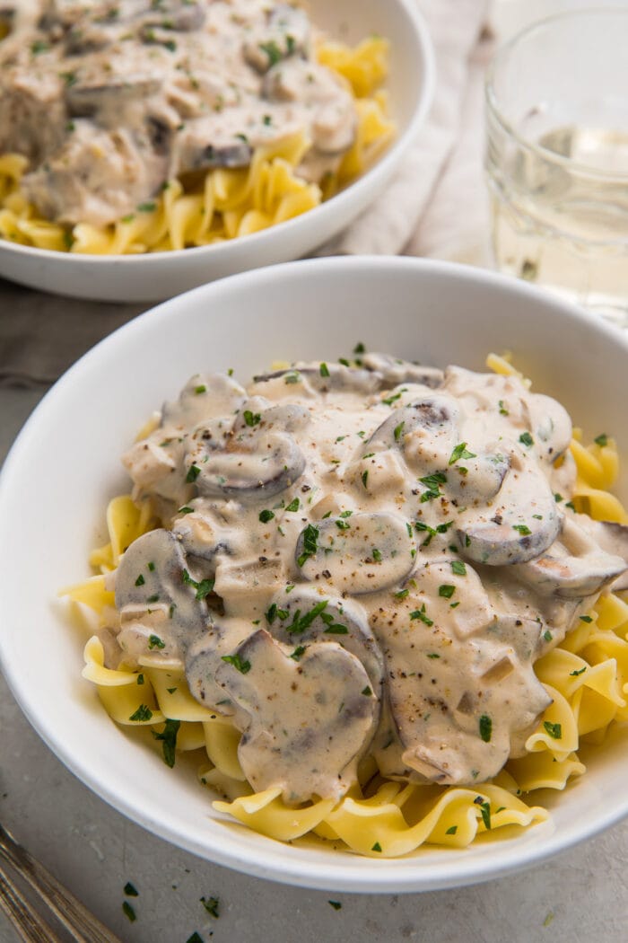 Two large white bowls of mushroom stroganoff