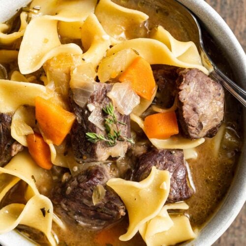 close-up overhead image of beef noodle soup in a bowl