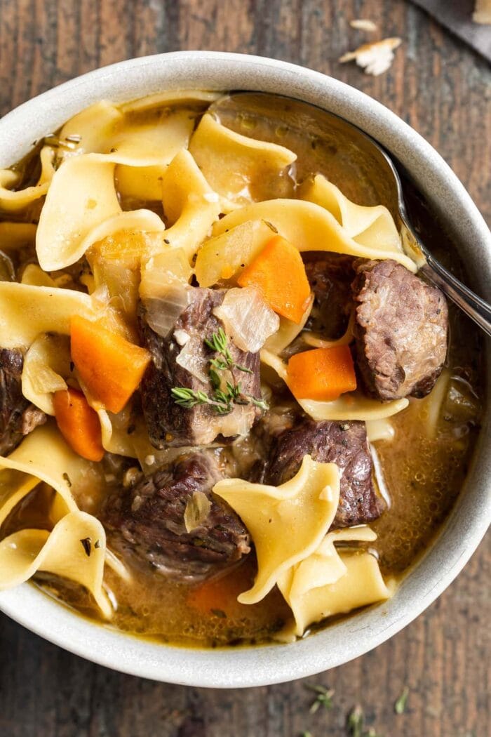 close-up overhead image of beef noodle soup in a bowl