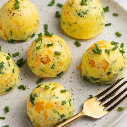 instant pot egg bites on a plate with fresh chopped chives on top