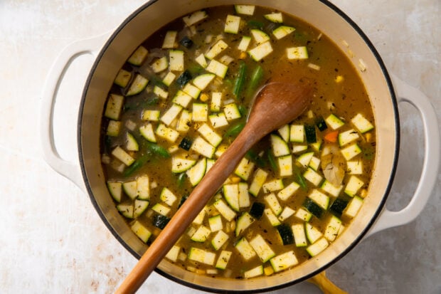 Chicken stock and frozen veggies in large saucepan