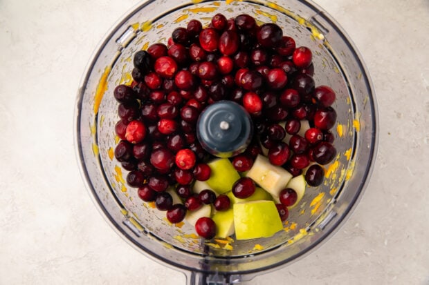 Apple and cranberries in food processor