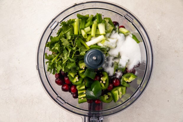 Ingredients for cranberry salsa in food processor bowl