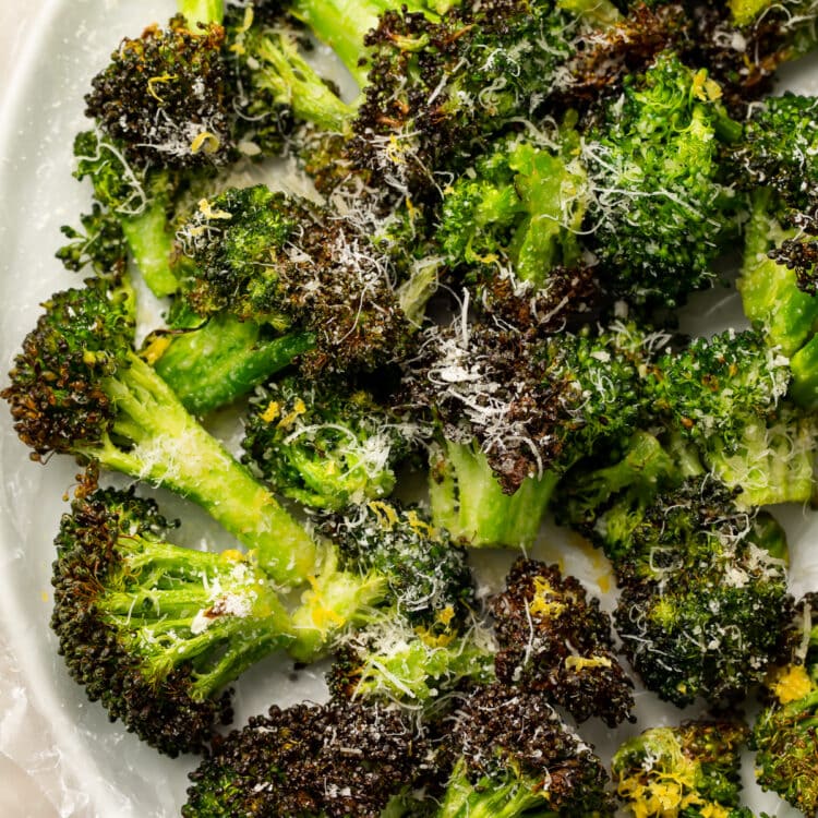 Overhead, closeup view of air fryer broccoli on a white plate