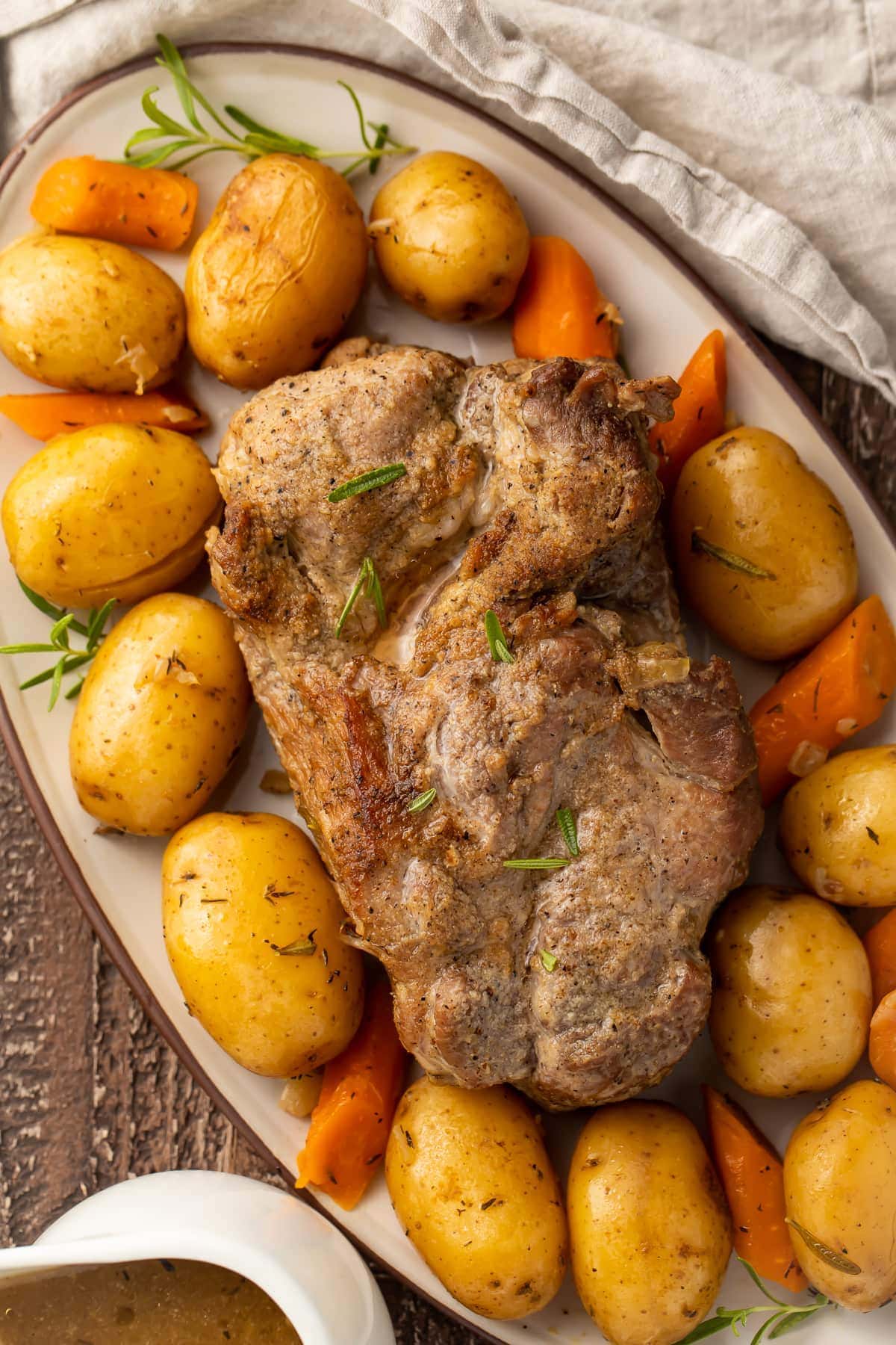 Instant Pot pork roast with carrots and potatoes on a large oval-shaped dish