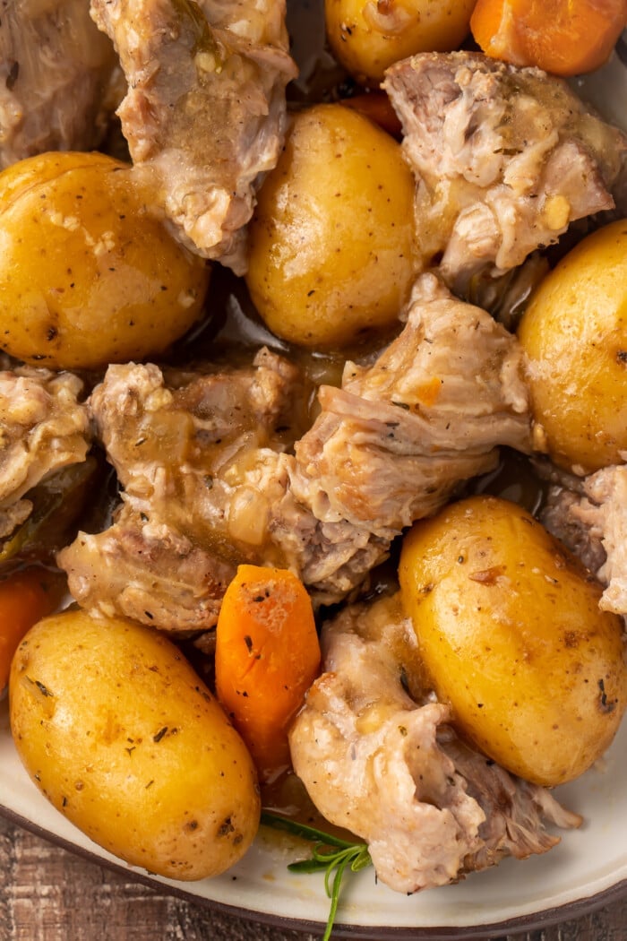 Instant Pot pork roast with carrots and potatoes on a large oval-shaped dish