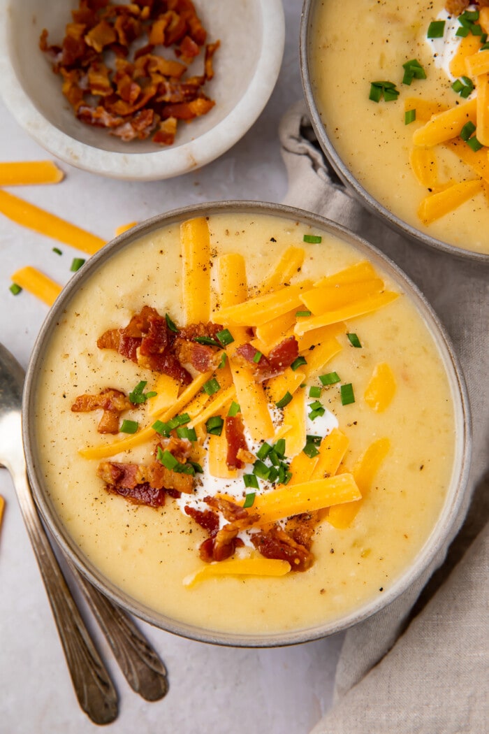 Overhead view of Instant Pot potato soup in black soup bowls