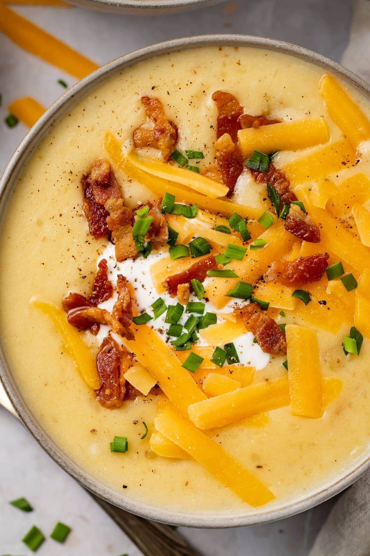 Overhead view of Instant Pot potato soup in black soup bowls