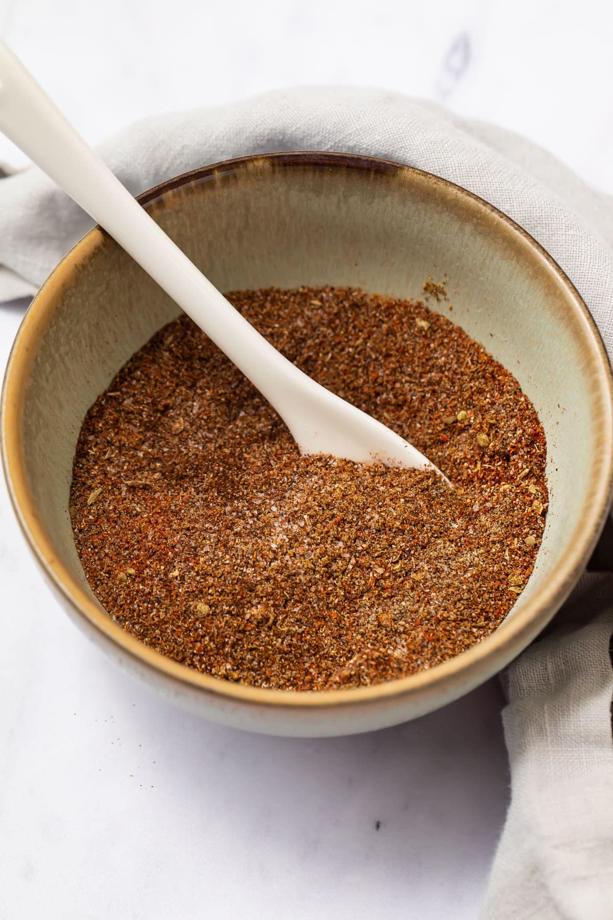 Keto taco seasoning in a bowl with a white spoon