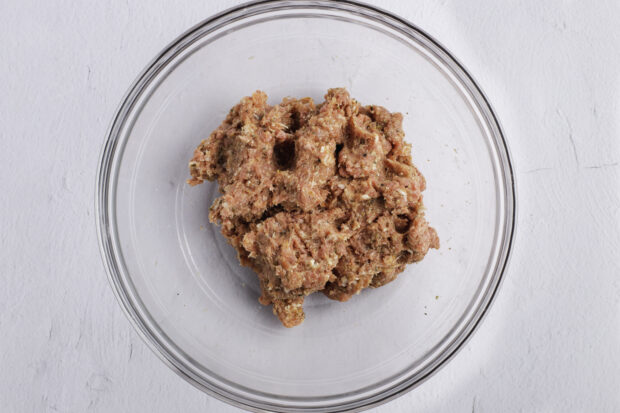 Meatball mixture in large glass bowl