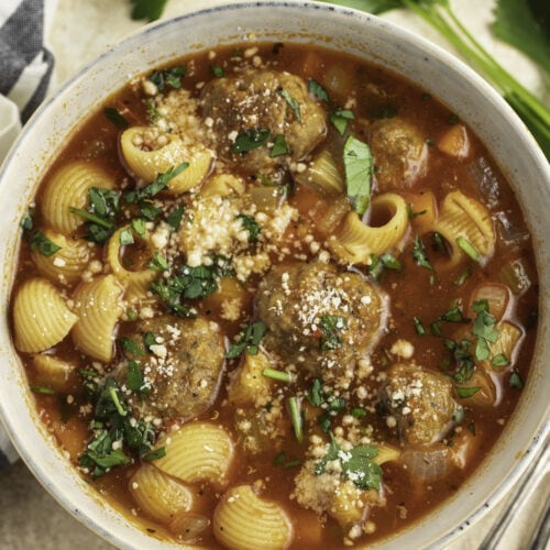 Overhead view of a bowl of meatball soup with noodles