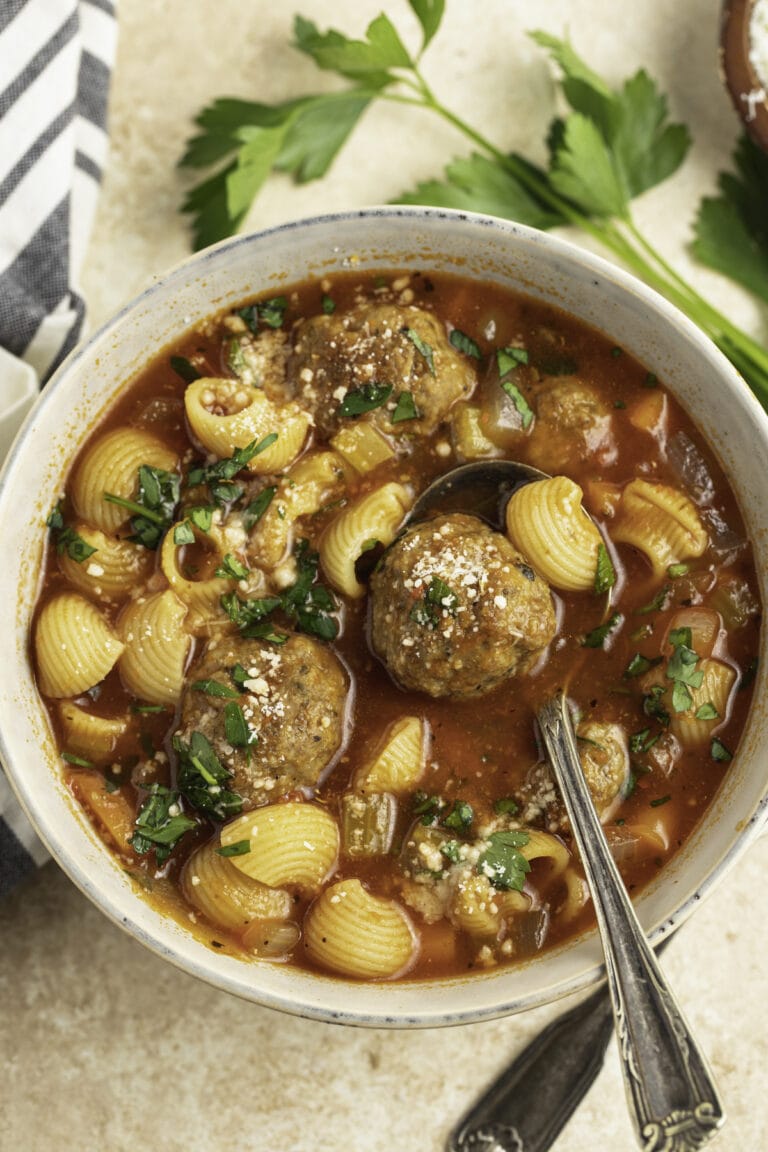 Overhead view of a bowl of meatball soup with noodles