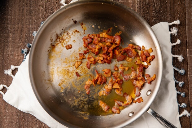 Diced bacon in large silver skillet