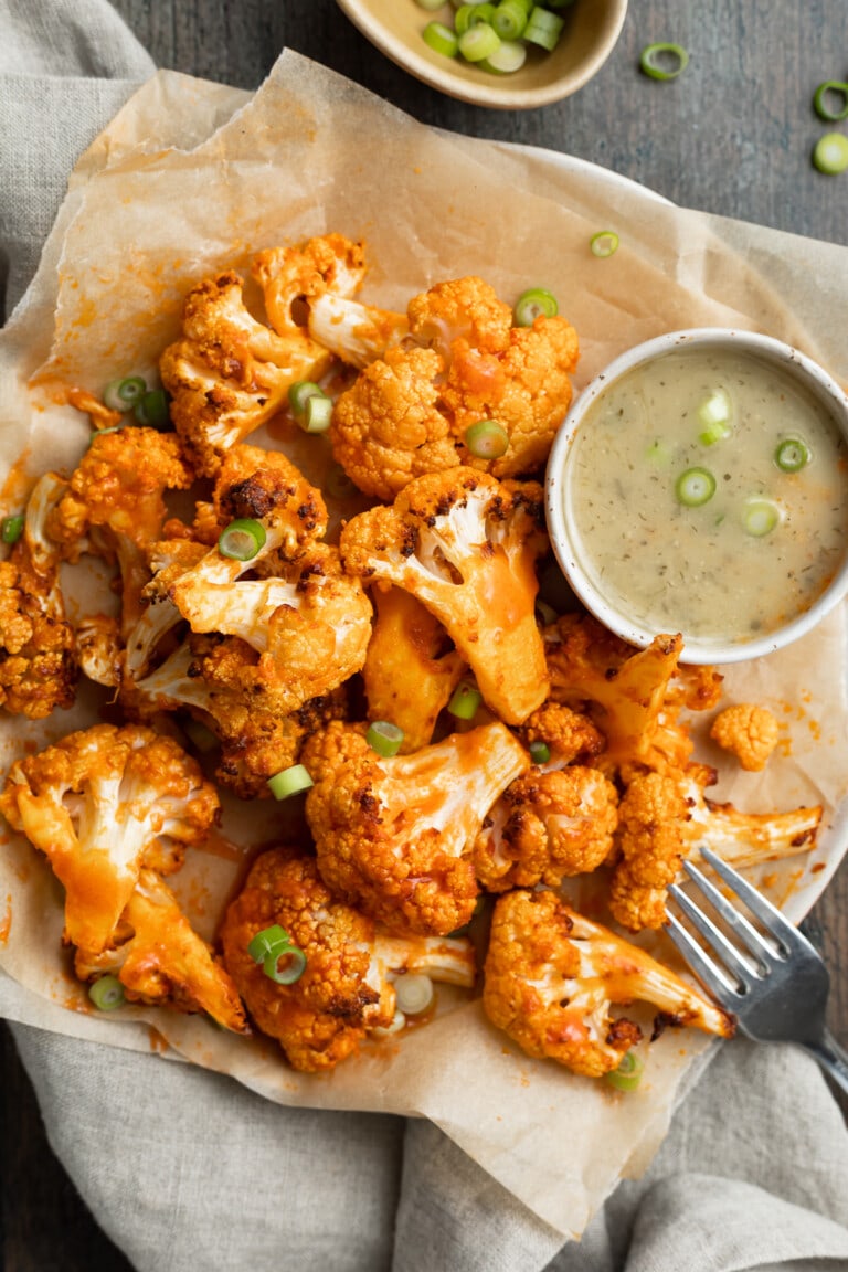 air fryer buffalo cauliflower on a plate with ranch on the side