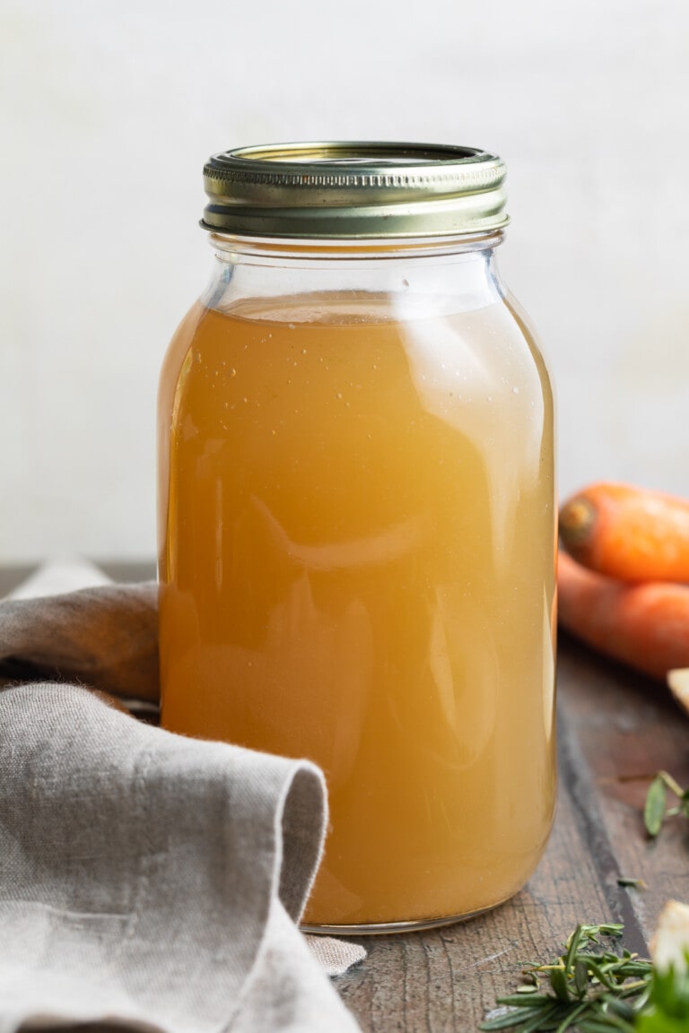 large jar of crockpot bone broth on a table.