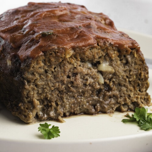 A closeup of a sliced loaf of paleo meatloaf on a plate