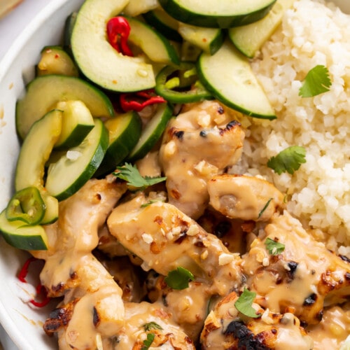 Overhead view of a Whole30 peanut chicken bowl with veggies