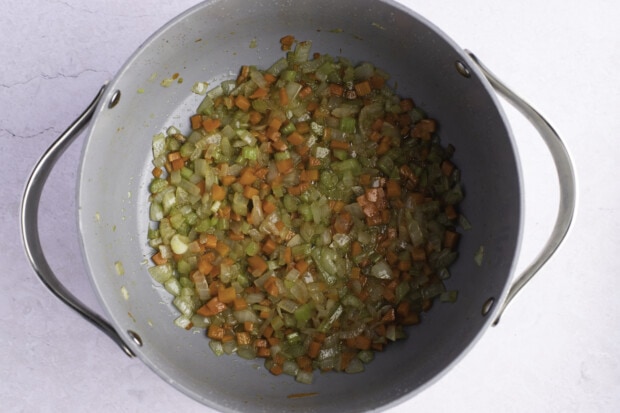 Onions, celery, and carrots in large heavy-bottomed pot with bacon drippings.