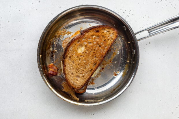 Fried egg sandwich in large skillet.