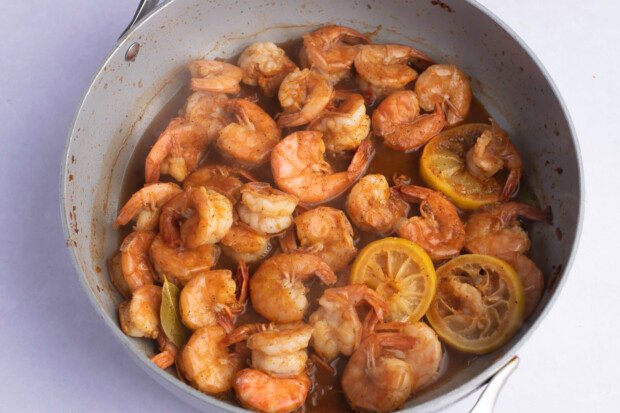 BBQ shrimp and lemon rounds in a large skillet.