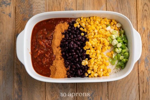 All ingredients for Mexican rice casserole in a casserole dish.