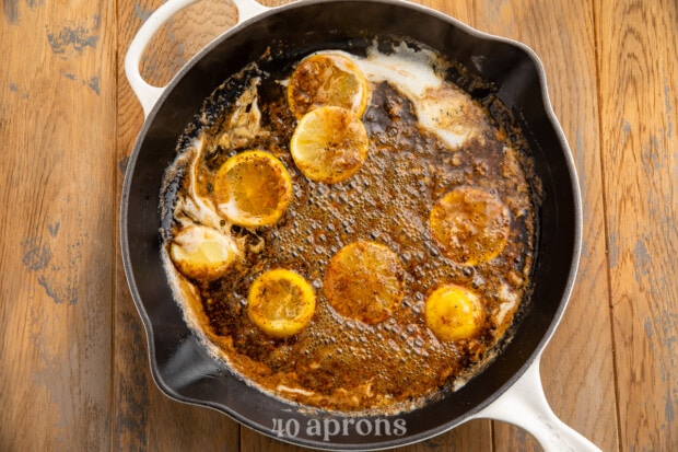 Overhead view of butter sauce ingredients for bbq shrimp po-boy in a large skillet.