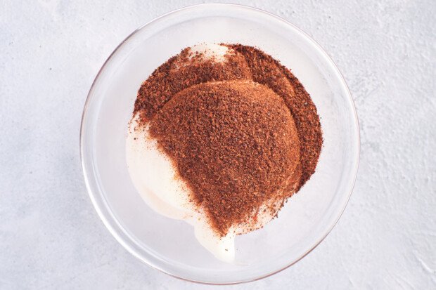 Overhead view of Whole30 mayo and chipotle chili powder in a small glass mixing bowl.