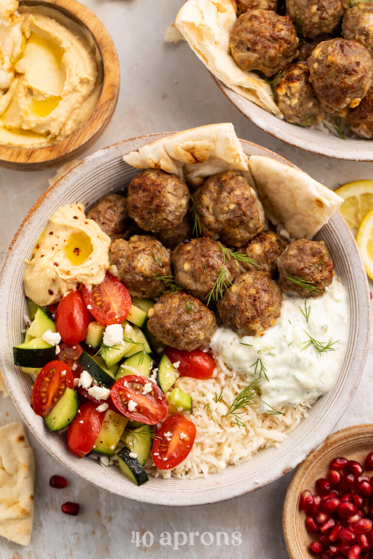 Overhead view of a gyro bowl with tender lemon rice and a creamy tzatziki sauce.