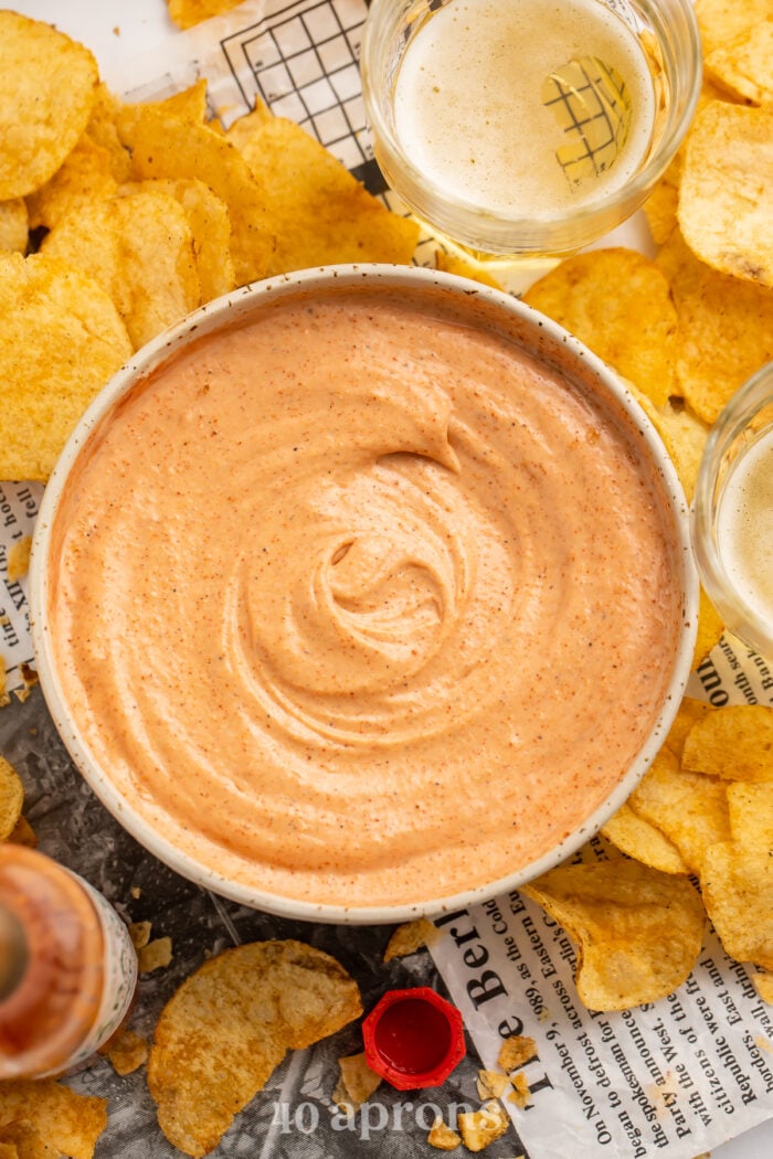 Overhead view of a bowl of cajun sauce surrounded by Zapp's potato chips.