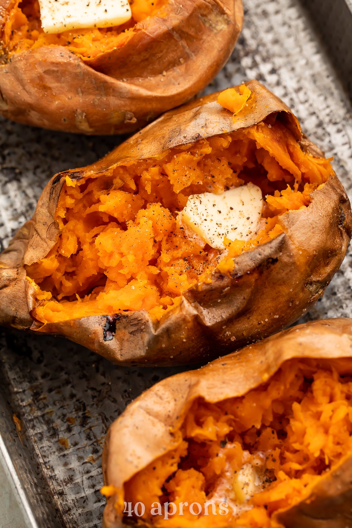 Overhead view of a row of cut-open air fryer sweet potatoes angling from the top left corner of the image to the bottom right corner.