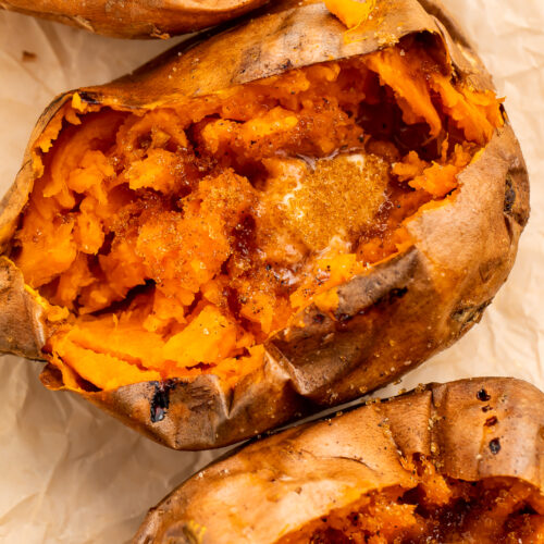 Overhead view of a row of cut-open sweet potatoes angling from the top left corner of the image to the bottom right corner.