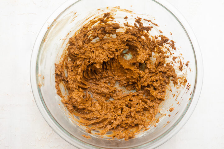 Overhead view of butter and brown sugar creamed together in a large mixing bowl.