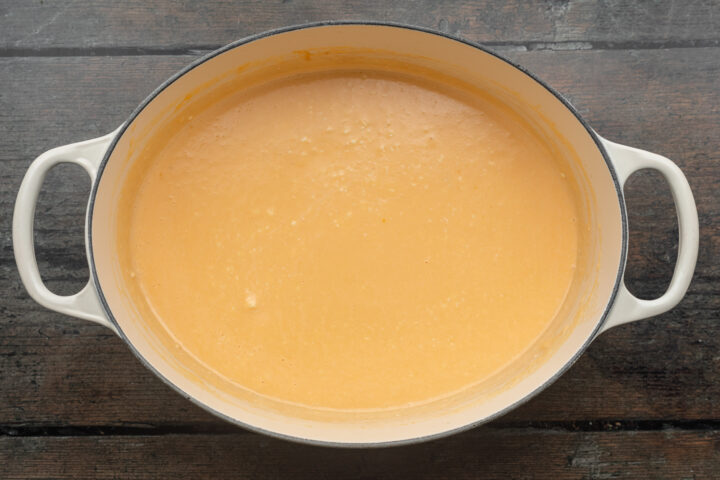 Overhead view of keto mac and cheese sauce in a large, heavy-bottomed pot.