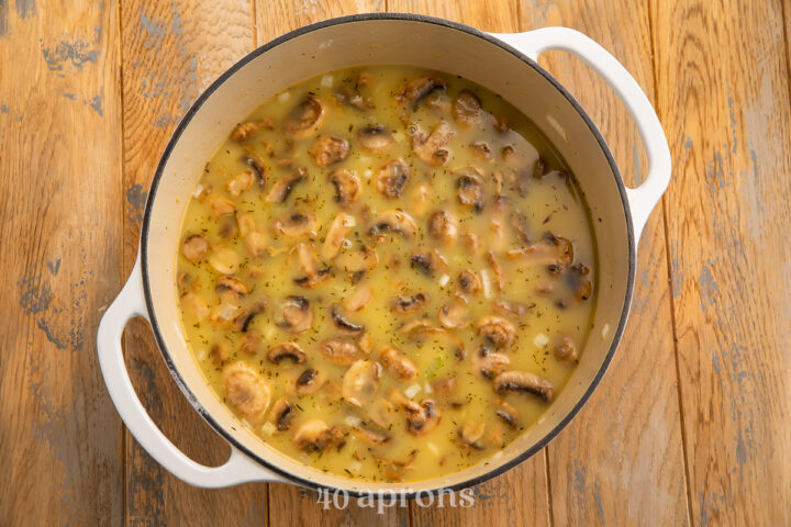 Overhead view of chicken and wild rice soup in a large heavy soup pot.