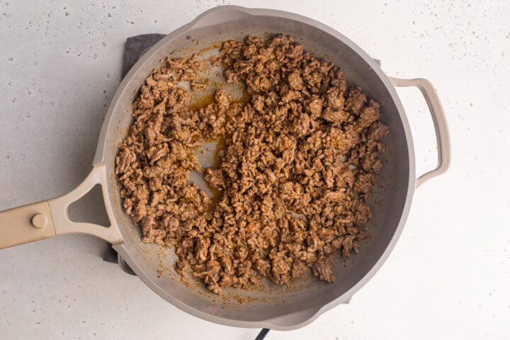 Ground beef with keto taco seasoning in a large skillet.