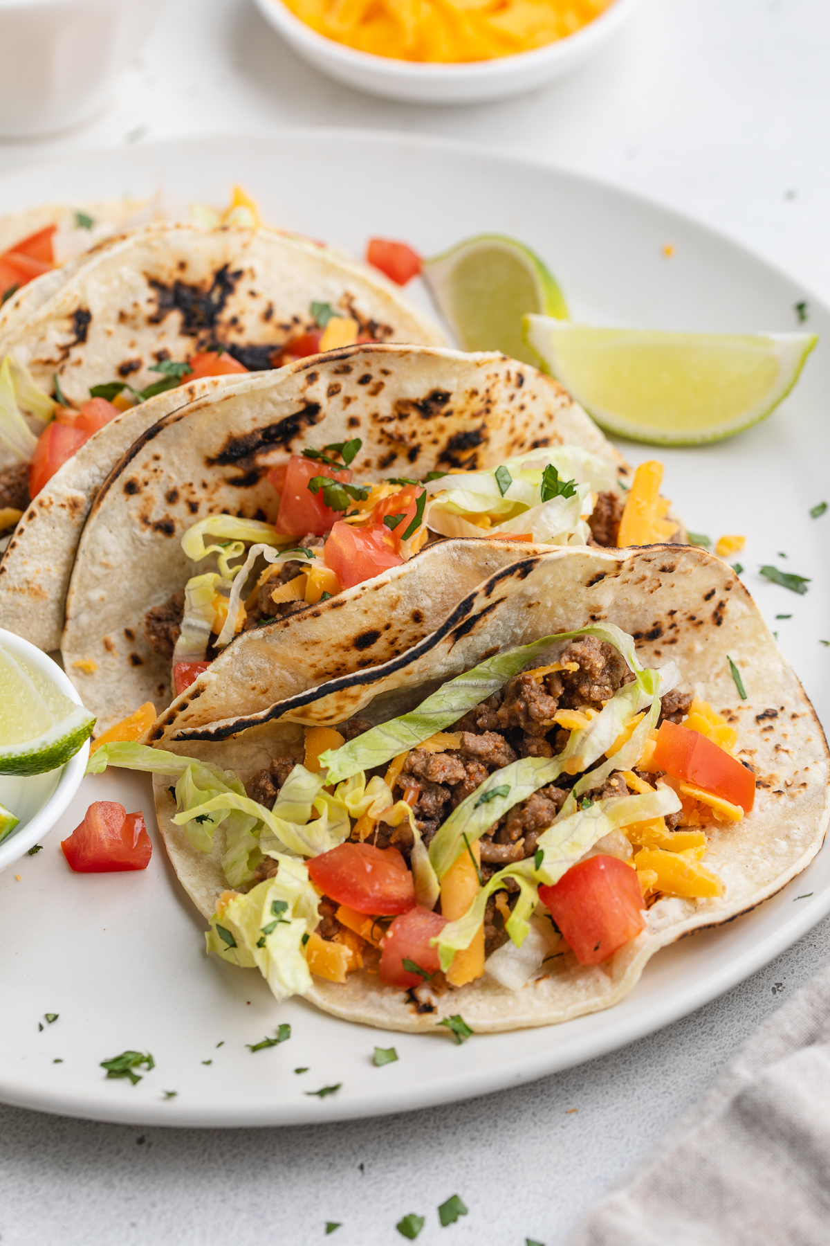 Zoomed out look at keto tacos lined up on a plate.