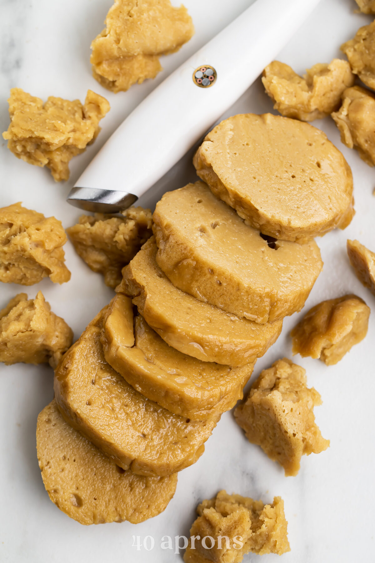 Overhead view of a seitan loaf sliced into rounds.