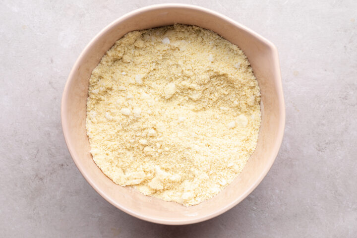 Dry ingredients for keto doughnut batter in a large pink mixing bowl.