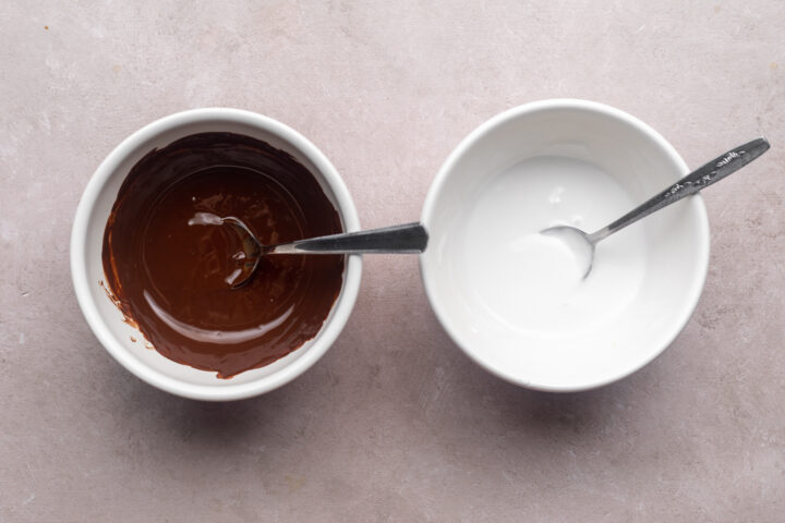 Overhead view of keto donut glazes (vanilla and chocolate) in mixing bowls.