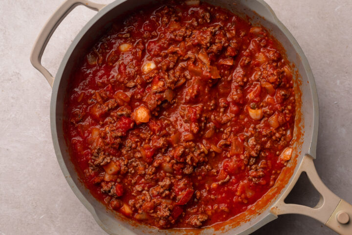 Ground beef in marinara sauce for gluten-free lasagna.