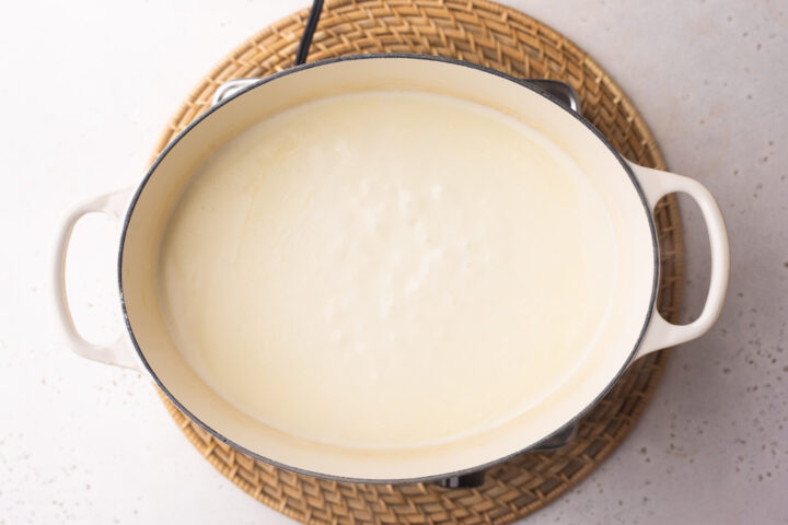 Overhead view of baking dish with lobster cheese sauce in a large oval baking dish with two handles.