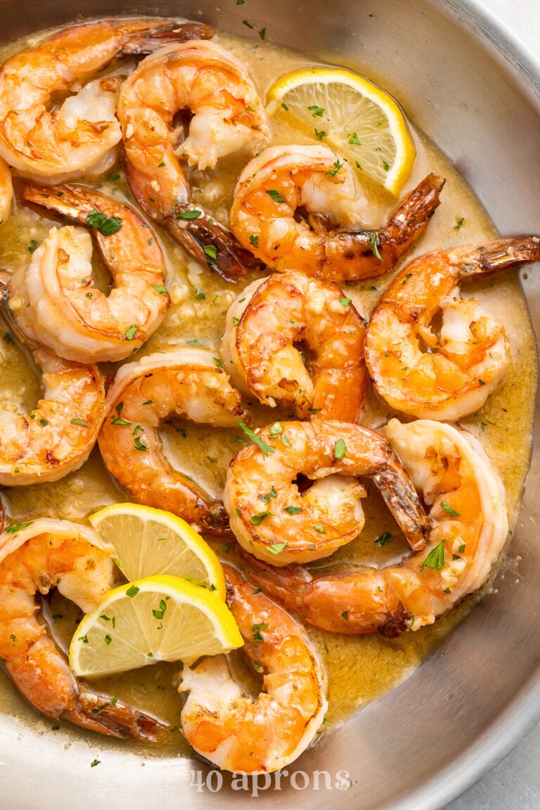 Sautéed garlic butter shrimp in a large silver skillet.