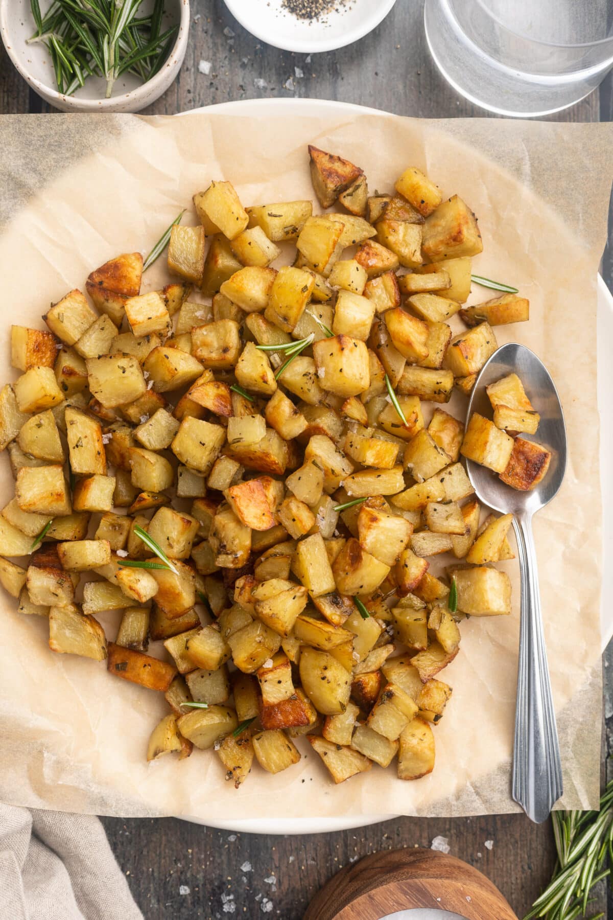 Overhead view of diced potatoes in a large bowl lined with parchment paper.