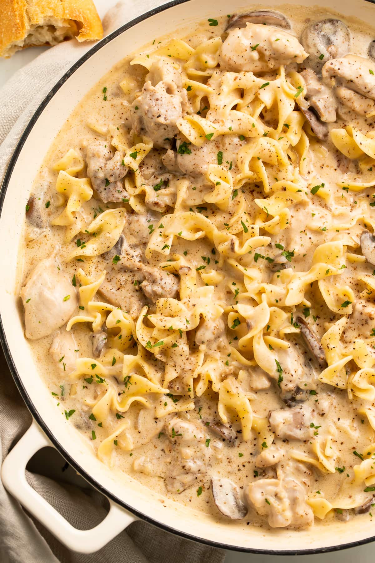 Chicken stroganoff with egg noodles in a large heavy-bottomed dish.