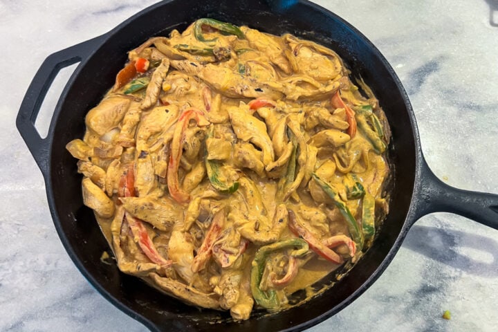 Chicken fajita casserole mixture in a cast-iron skillet.