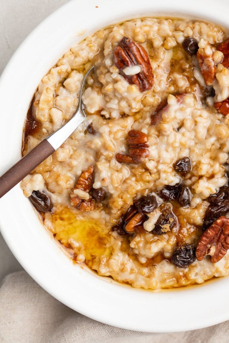 A bowl of Instant Pot steel cut oats topped with pecans and raisins.