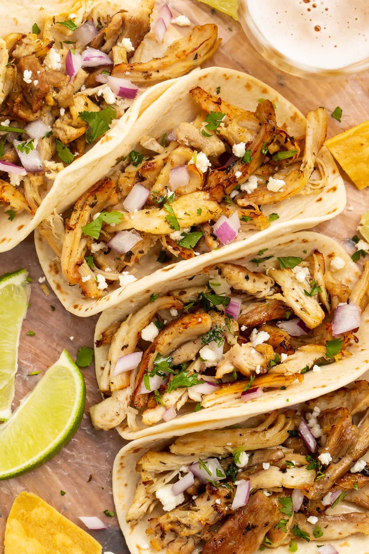 Zoomed out photo of a chicken carnitas taco with Instant Pot chicken carnitas.