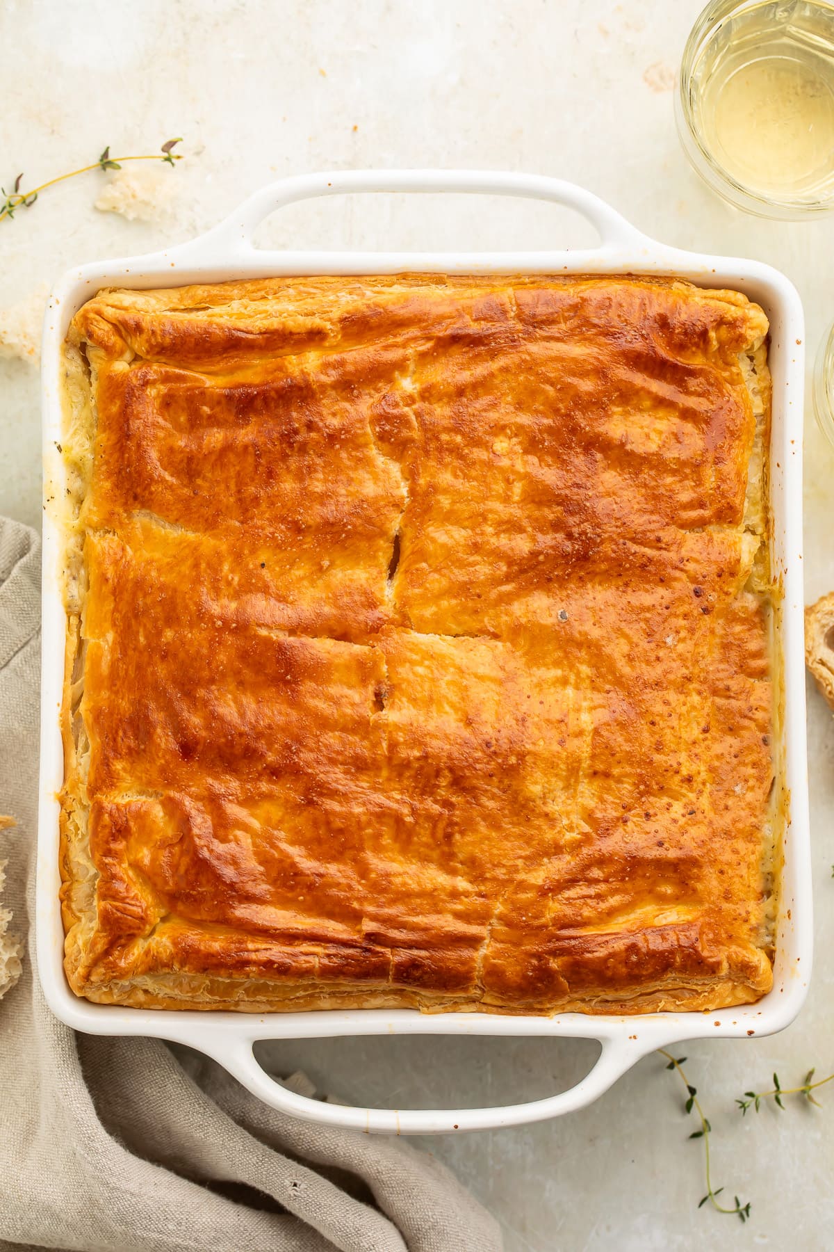 Overhead view of a chicken pot pie casserole in a square casserole dish.