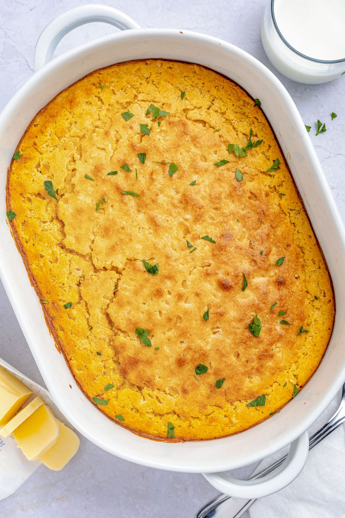 Overhead view of a large oval casserole dish holding a cornbread casserole.